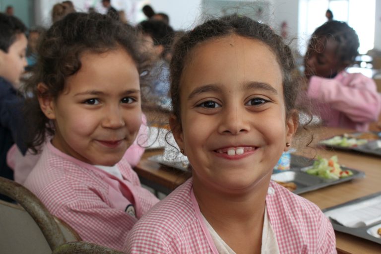 Girls in Tunisia receiving a school meal