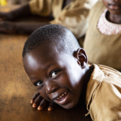 School feeding Young Benin Student smiles at the camera