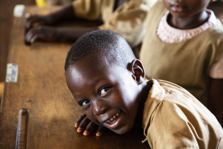 School feeding Young Benin Student smiles at the camera